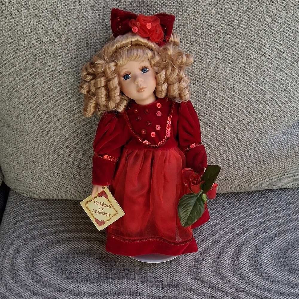 Elegant Red Porcelain Doll with Bow
